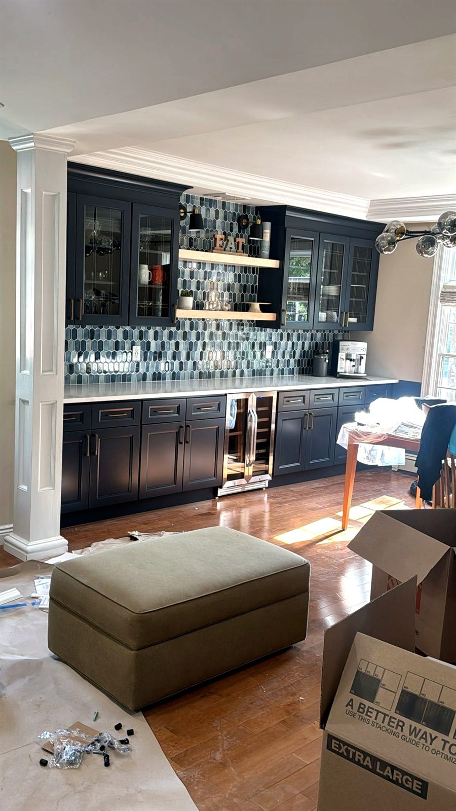 Navy built-in dry bar with glass-front cabinets and picket tile backsplash