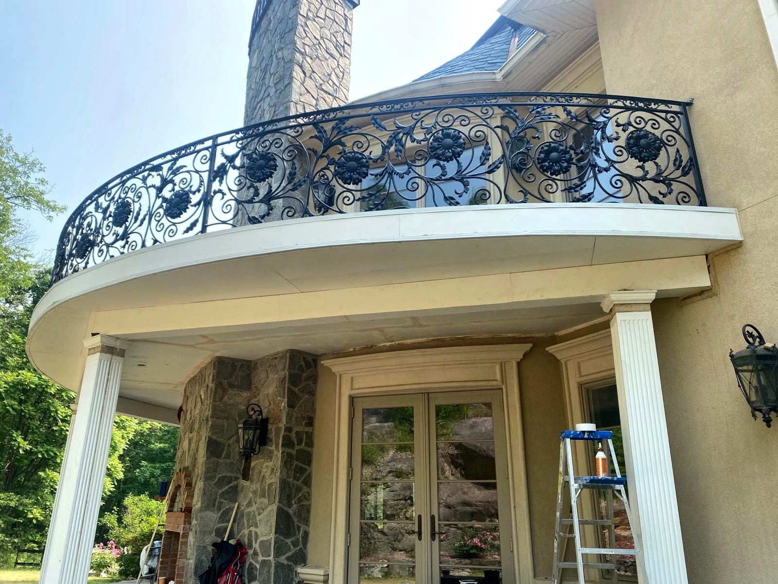 Curved balcony with ornamental iron railing